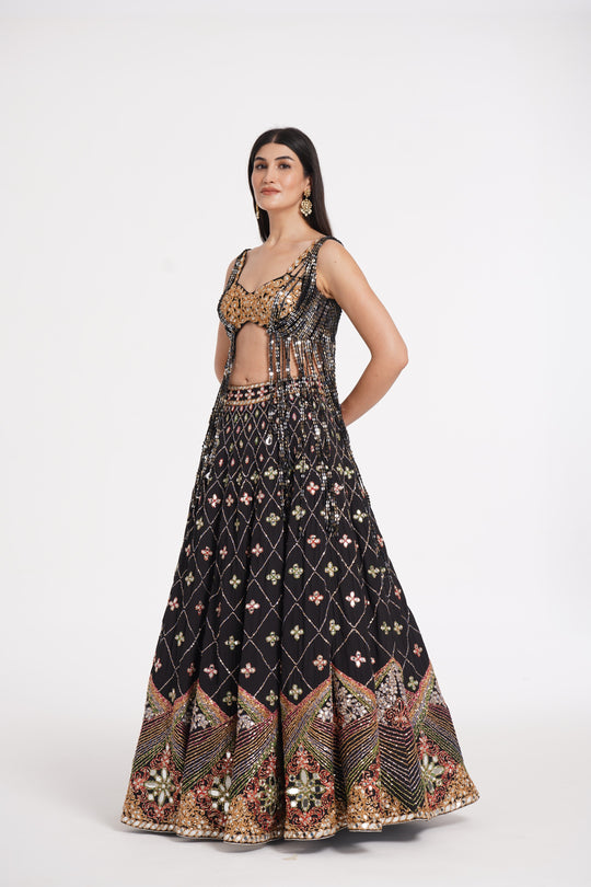 Abhinav Mishra - Matte black fringes blouse and skirt embellished using warm pastels